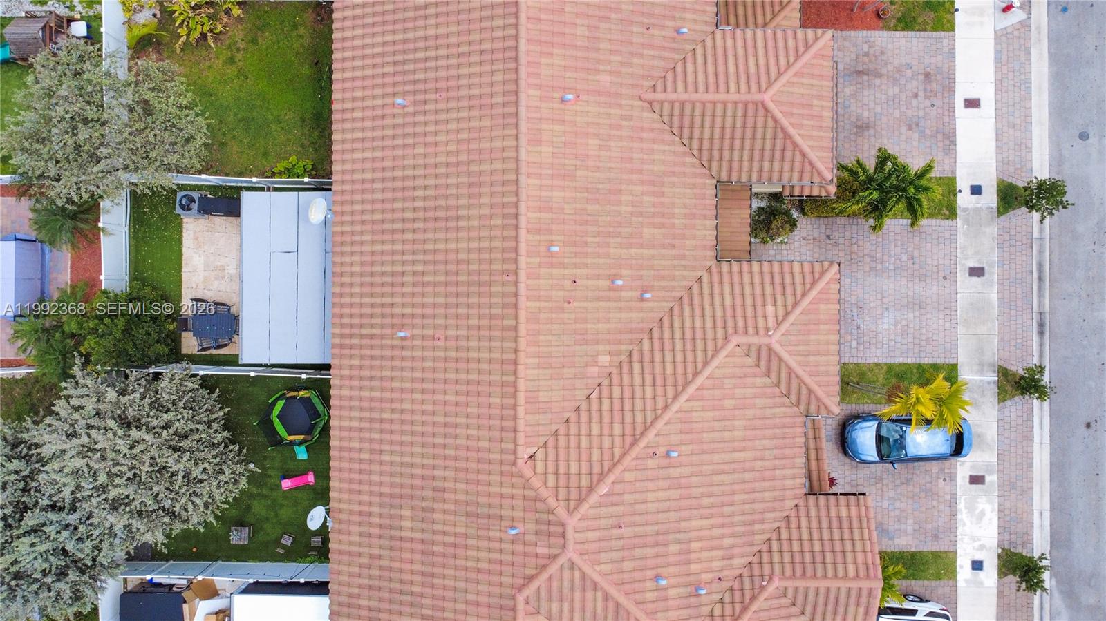 An aerial view shows a house with a tiled roof, a backyard, and a driveway — 3323 W 90th Ter, Hialeah FL 33018, HIALEAH, FL