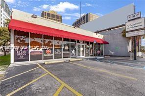 A commercial building with a red awning and glass storefront sits next to a parking lot — 9308 S Dixie Hwy, Miami FL 33156, MIAMI, FL