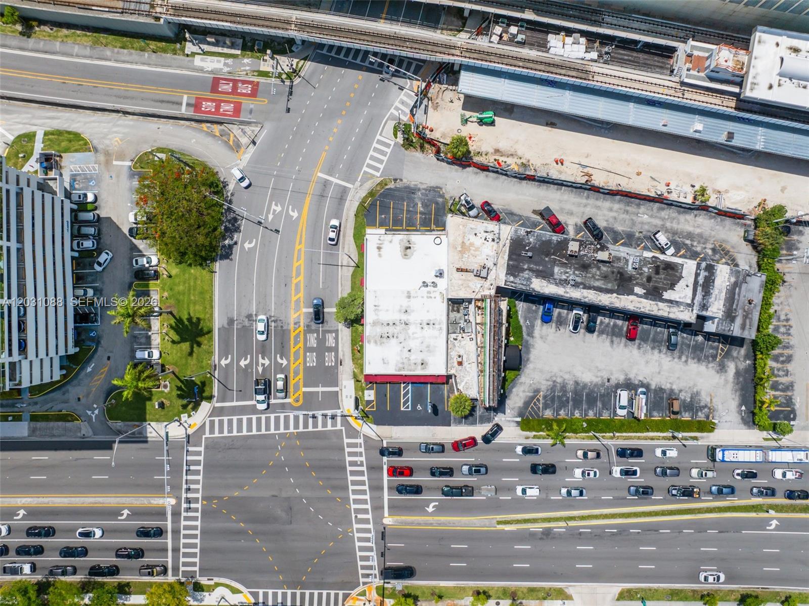 An aerial view shows a commercial building outlined in red situated next to a highway — 9308 S Dixie Hwy, Miami FL 33156, MIAMI, FL