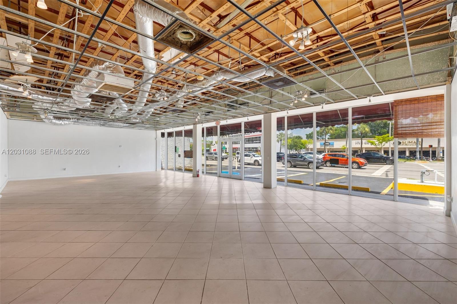 This aerial view shows a commercial building outlined in red with adjacent parking lots — 9308 S Dixie Hwy, Miami FL 33156, MIAMI, FL