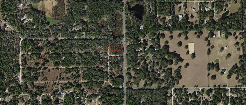 An aerial view shows a rectangular plot of land outlined in red along a road — 8927 N VALENTINE TERRACE, CRYSTAL RIVER, FL