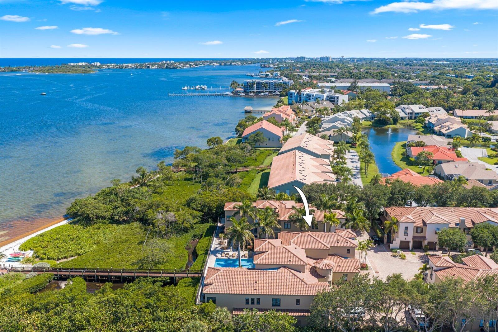 An aerial view of a waterfront house with a pool, patio, and surrounding tropical landscaping — 920 Via Villagio, Hypoluxo FL 33462, HYPOLUXO, FL