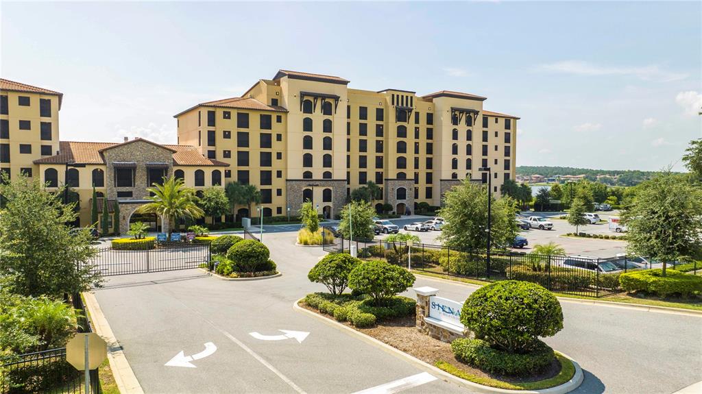 A multi-story apartment building with a gated entrance and a parking lot — 16300 COUNTY ROAD 455 UNIT 606, MONTVERDE, FL