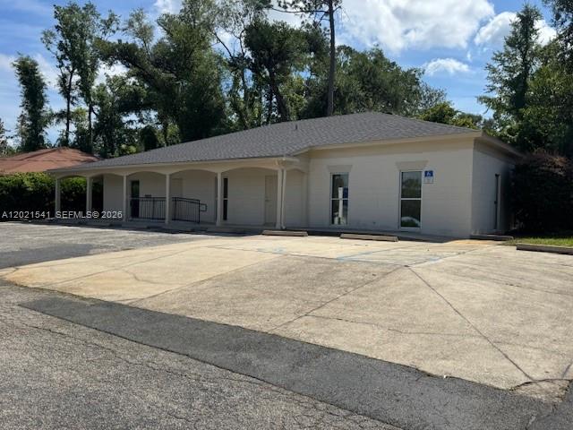 A single-story commercial building with a covered walkway and a paved parking lot — 1707 S Gadsden, Tallahassee FL 32301, TALLAHASSEE, FL