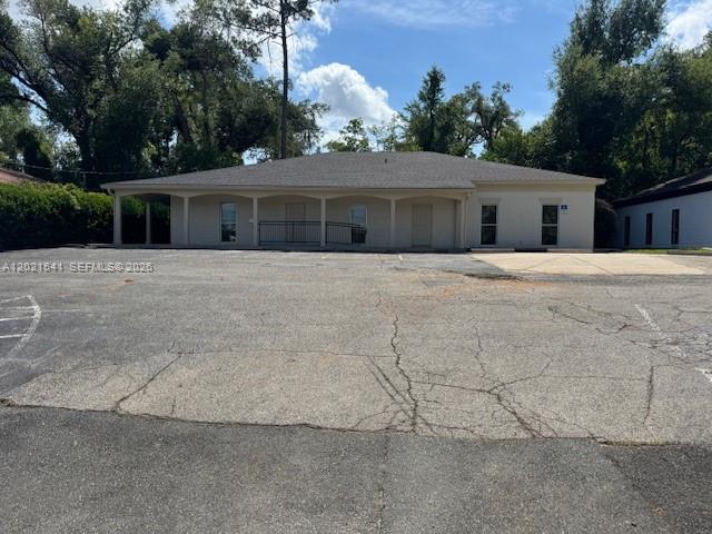 A single-story commercial building with a covered walkway and parking lot in front — 1707 S Gadsden, Tallahassee FL 32301, TALLAHASSEE, FL