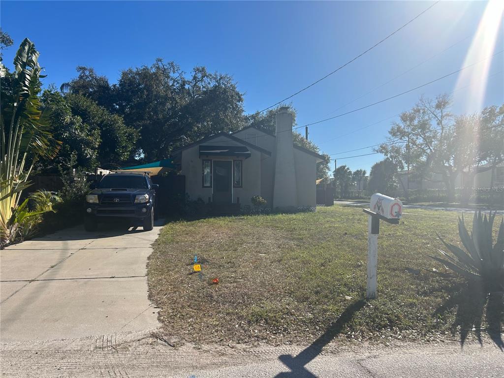 A single-story house with a concrete driveway, a front chimney, and a mailbox — 3324 W MARLIN AVENUE, TAMPA, FL