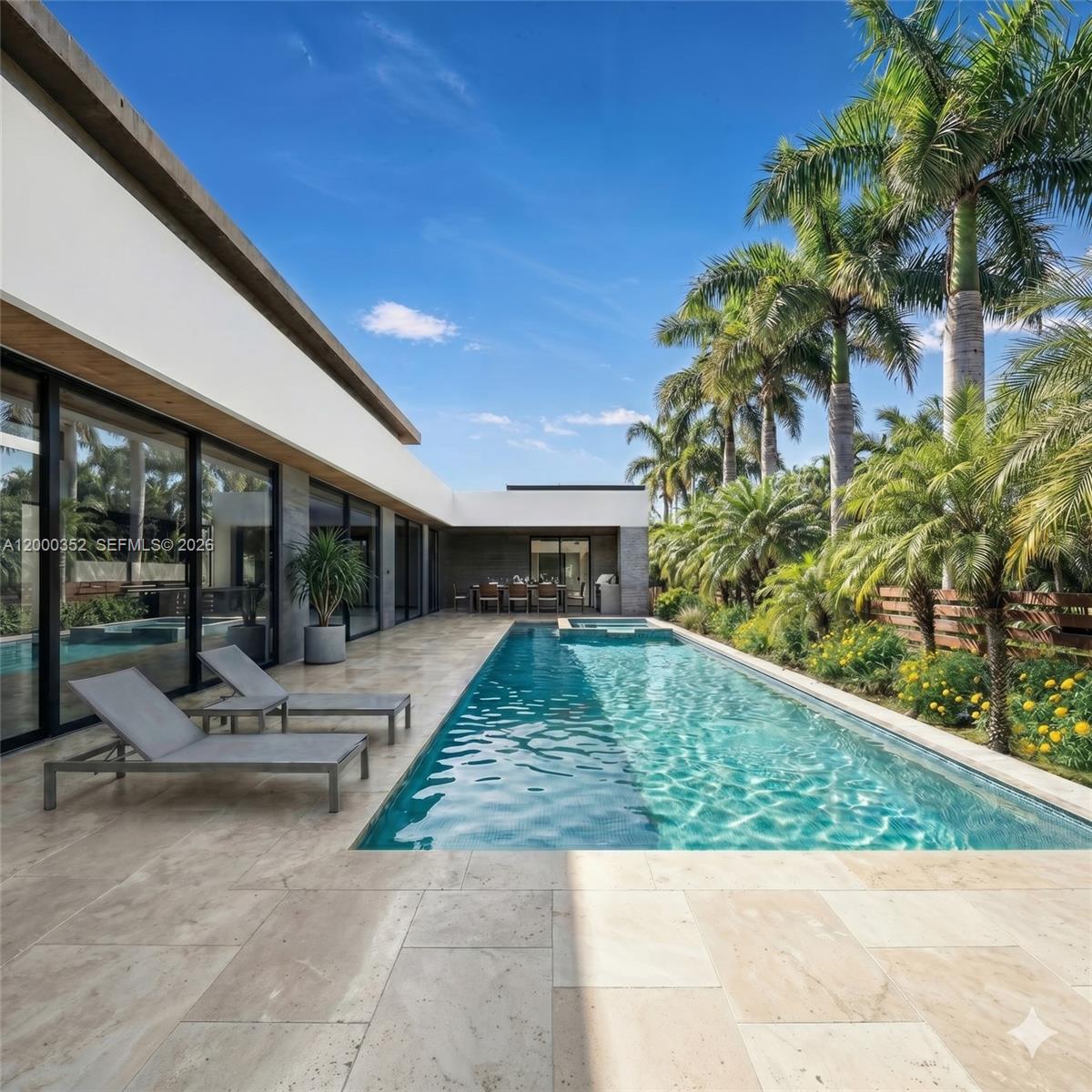 A rendering of a modern house exterior at night with a paved driveway and landscaping — 789 NE 83rd Street, Miami FL 33138, MIAMI, FL