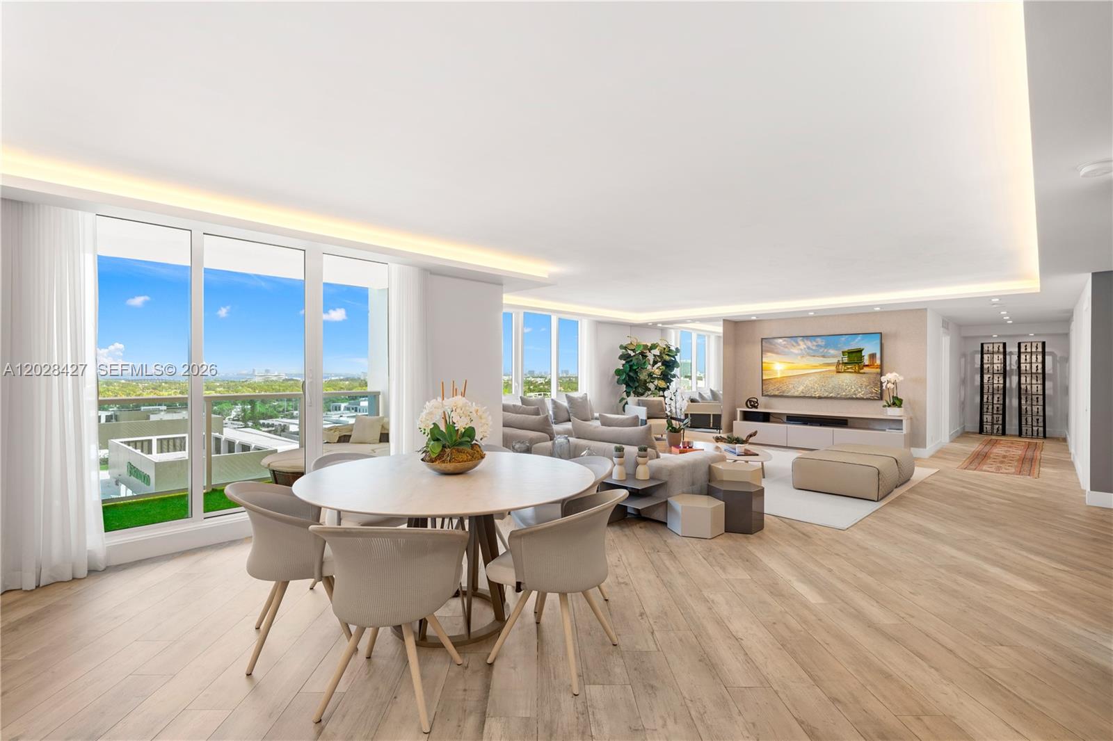 A bright, open-concept living and dining area features light wood flooring and floor-to-ceiling windows — 2301 Collins Ave # 1432, Miami Beach FL 33139, MIAMI BEACH, FL