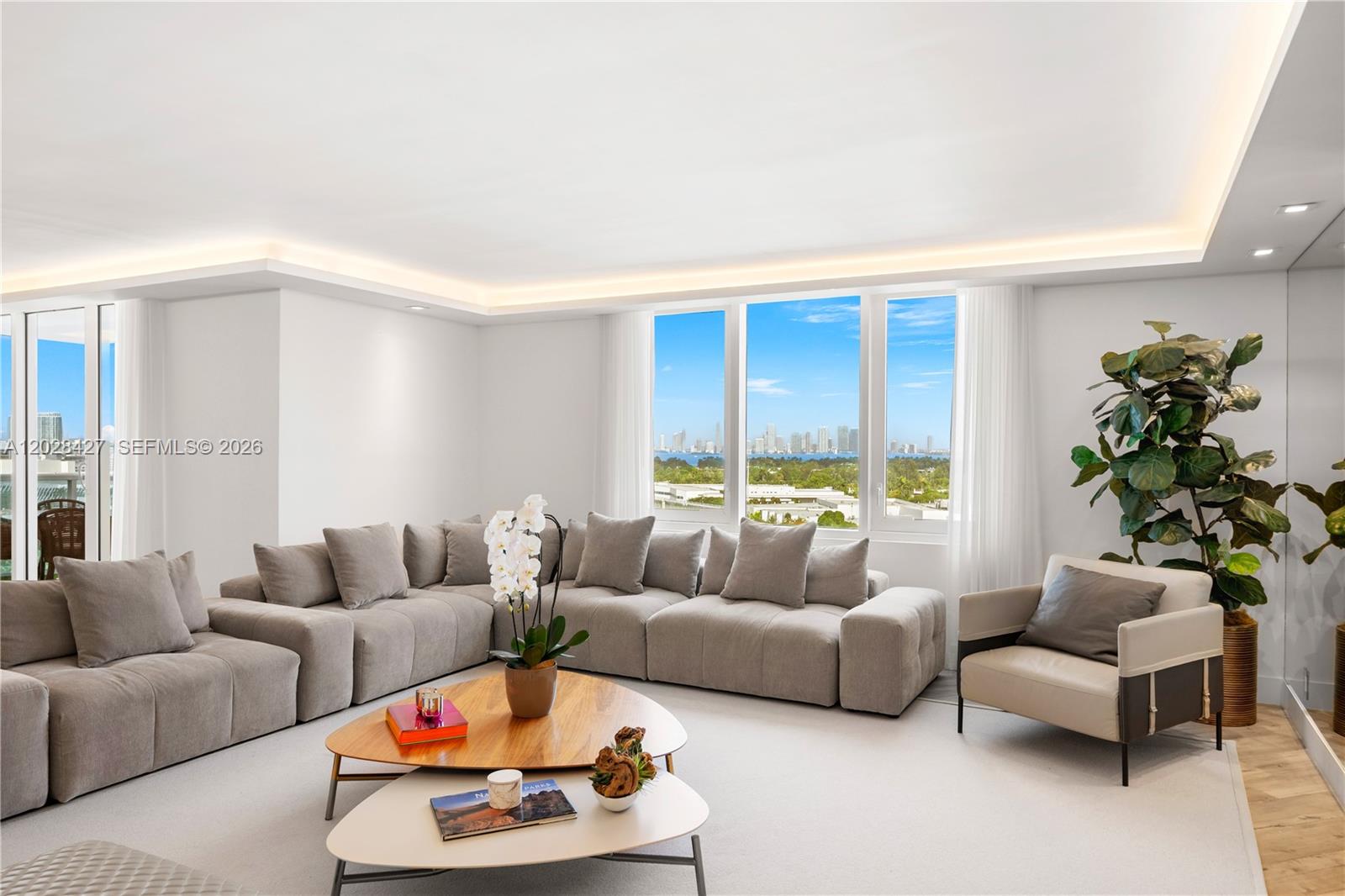 A living room features a large grey sectional sofa, two coffee tables, and city views — 2301 Collins Ave # 1432, Miami Beach FL 33139, MIAMI BEACH, FL