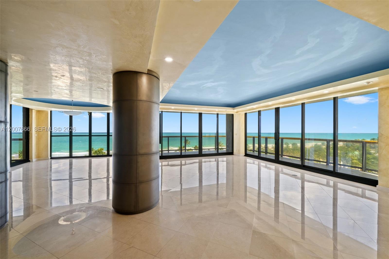 An empty room with marble floors, a large central column, and floor-to-ceiling ocean views — 9999 Collins Ave # 6G, Bal Harbour FL 33154, BAL HARBOUR, FL