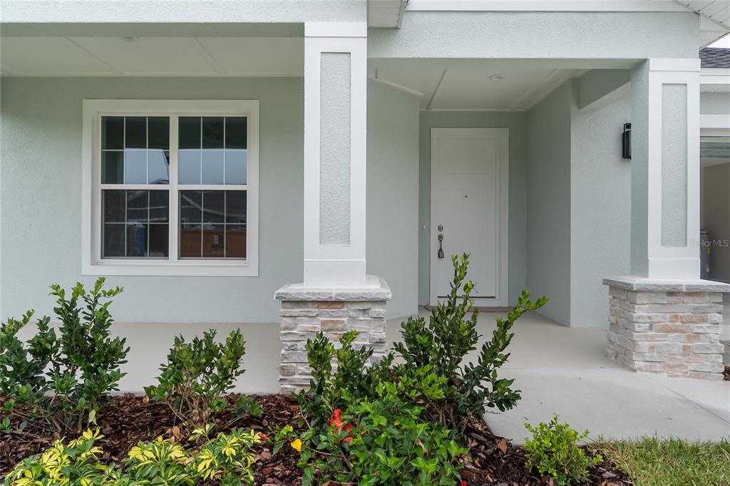An aerial view shows a single-story house with a white exterior and gray roof — 4545 FAIRWAY OAKS DRIVE, MULBERRY, FL