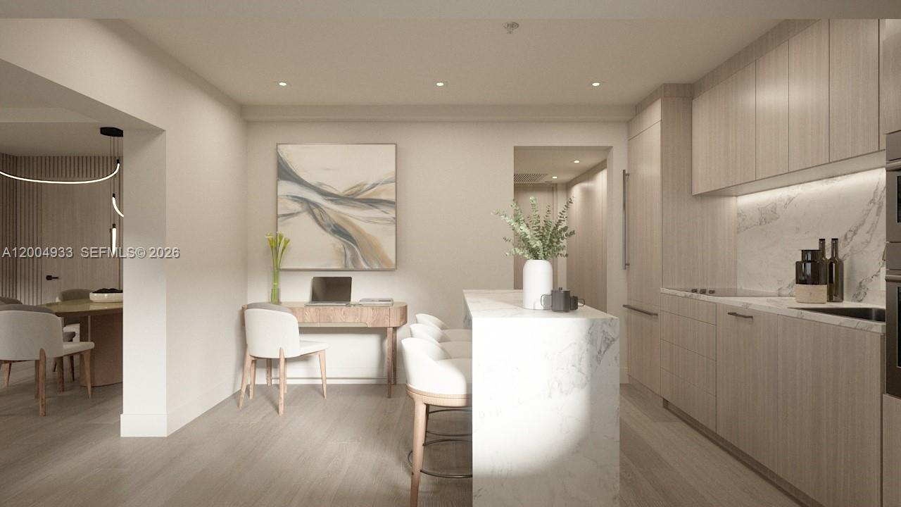 This is a rendering of a modern kitchen with a marble island and light wood cabinetry — 260 Collins Ave # 105, Miami Beach FL 33139, MIAMI BEACH, FL