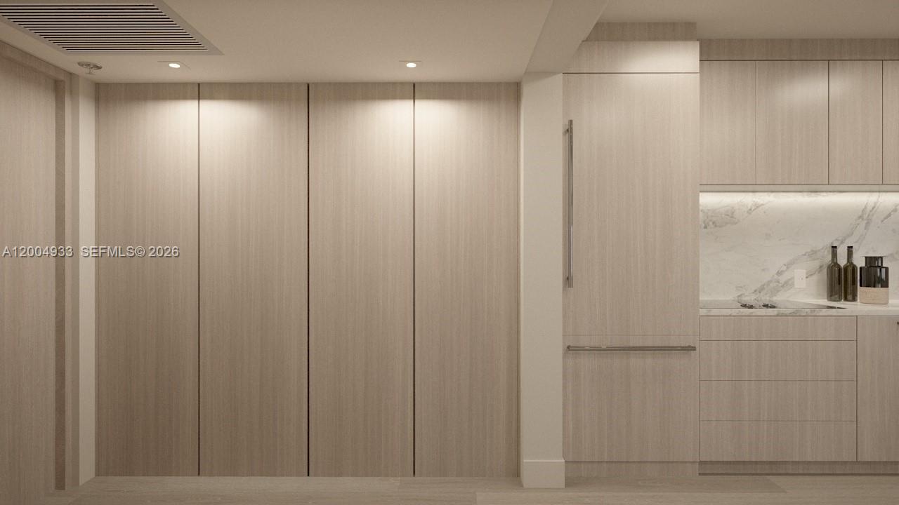 This is a rendering of a modern kitchen featuring light wood cabinetry and integrated appliances — 260 Collins Ave # 105, Miami Beach FL 33139, MIAMI BEACH, FL