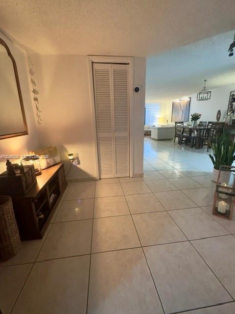 A tiled entryway leads to a dining area and living room with white louvered closet doors — 13951 Kendale Lakes Cir # 807A, Miami FL 33183, MIAMI, FL