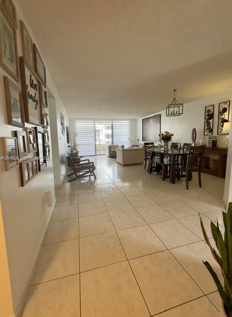 A spacious living and dining area features light tile flooring and a wall gallery — 13951 Kendale Lakes Cir # 807A, Miami FL 33183, MIAMI, FL