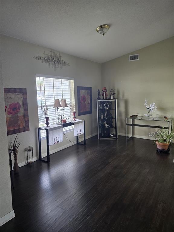 A room with dark wood flooring, a window, a display cabinet, and two console tables — 2956 COACH LAMP ROAD, MULBERRY, FL