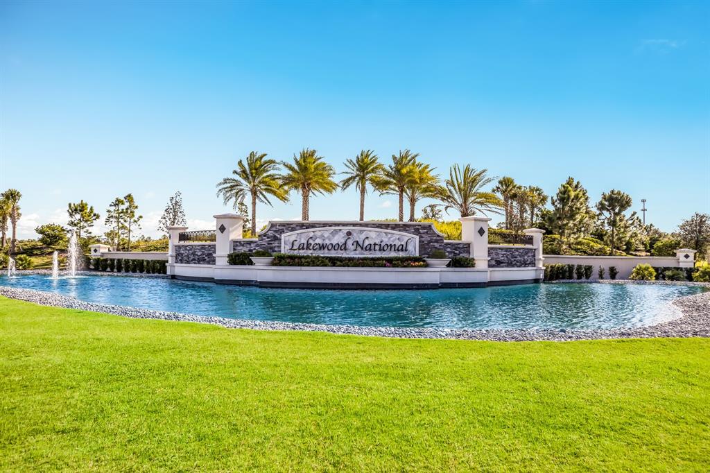 A stone monument sign for Lakewood National sits behind a pond with fountains and palms — 5557 PALMER CIRCLE UNIT 202, BRADENTON, FL
