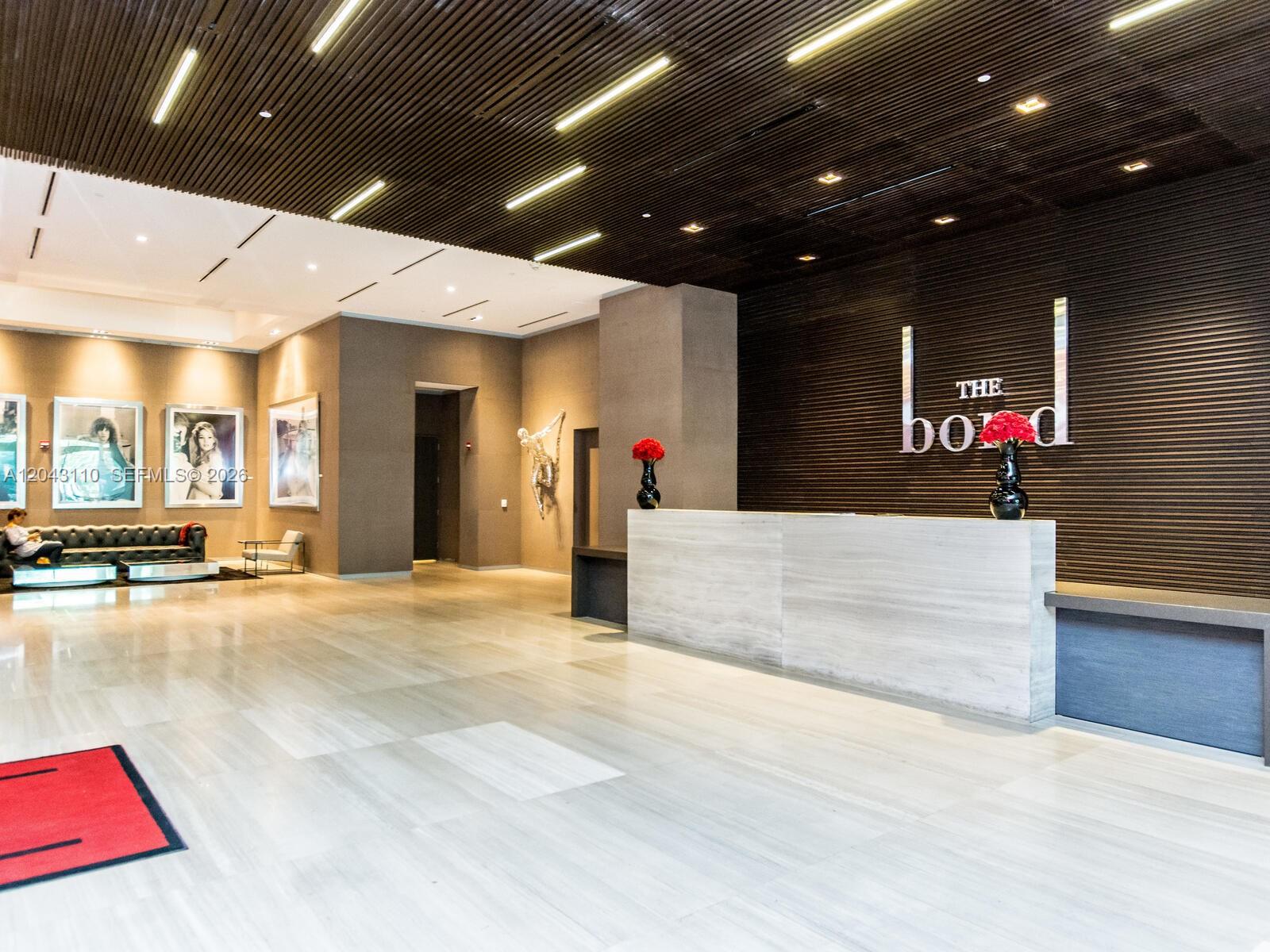 A balcony with a white sofa overlooks a dense urban skyline with tall skyscrapers — 1080 Brickell Ave # 1509, Miami FL 33131, MIAMI, FL