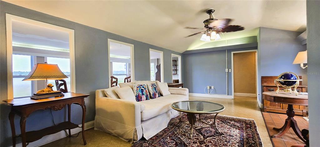 A living room features a white sofa, a glass coffee table, and a ceiling fan — 240 MASTERPIECE ROAD, LAKE WALES, FL