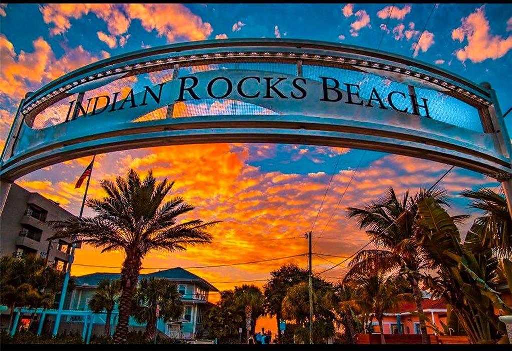 An arched metal sign reading Indian Rocks Beach stands against a vibrant sunset sky — 372 12TH AVENUE, INDIAN ROCKS BEACH, FL