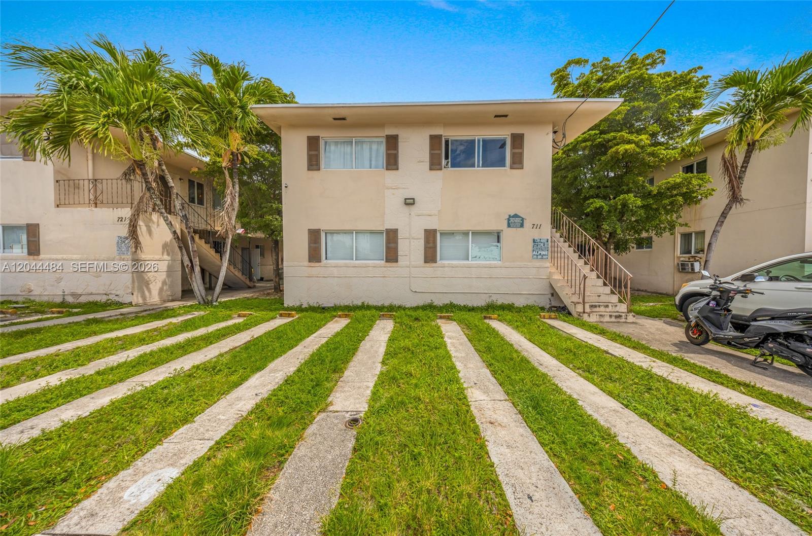 A two-story apartment building features a concrete parking area with grass strips in front — 731 SW 5th St, Miami FL 33130, MIAMI, FL