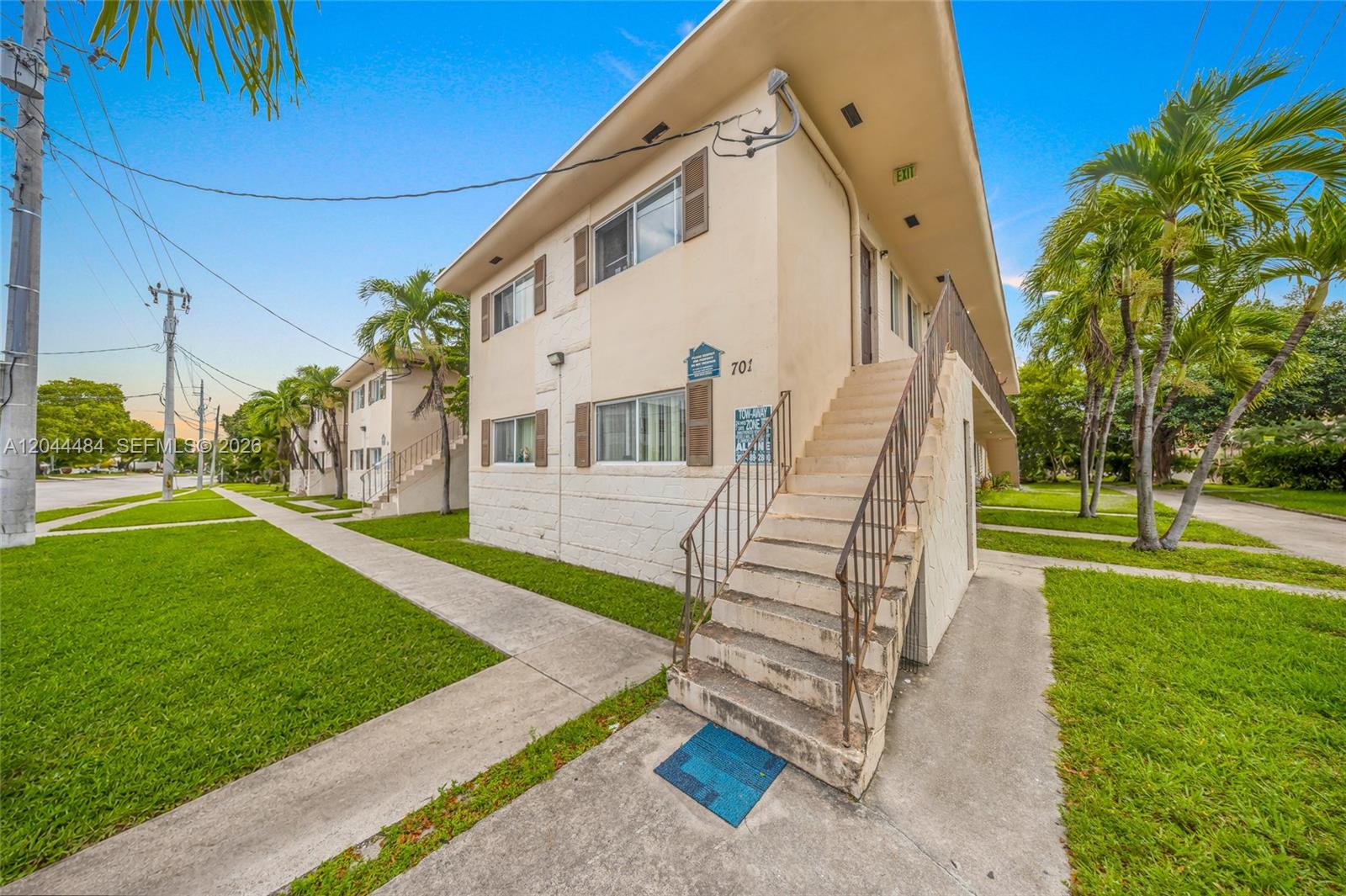 A two-story apartment building exterior features concrete stairs leading to an upper-level walkway — 731 SW 5th St, Miami FL 33130, MIAMI, FL