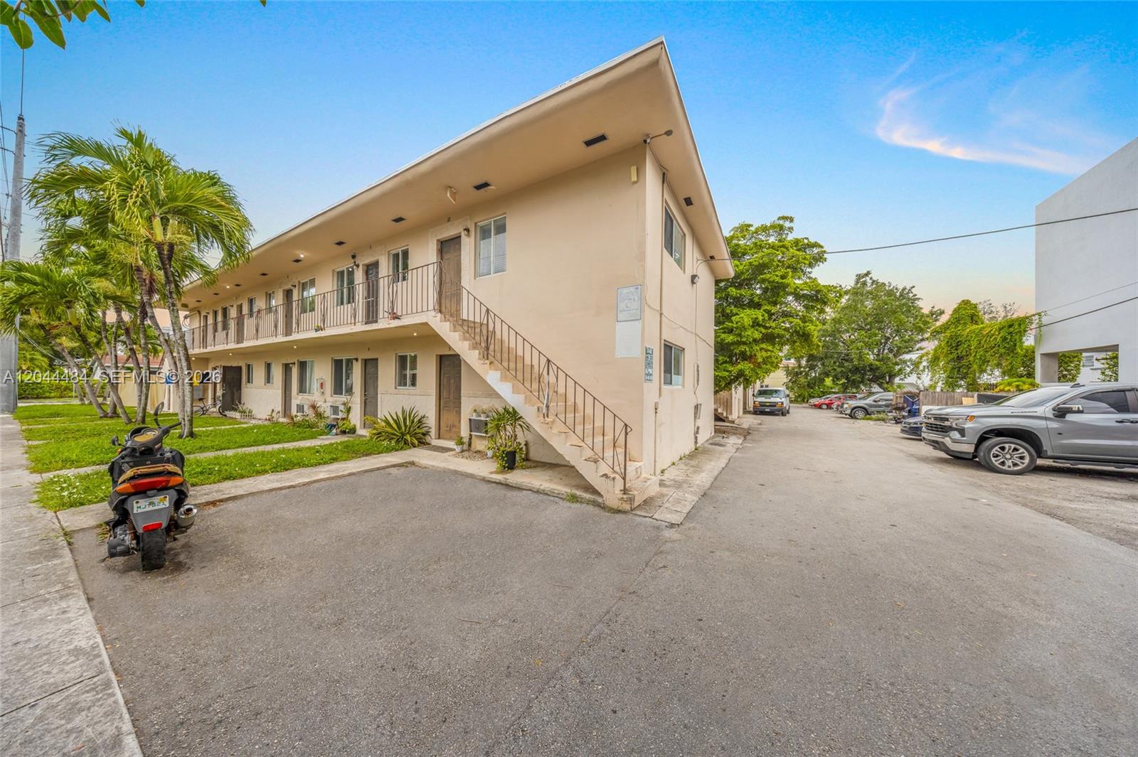 A two-story apartment building features an exterior staircase and a paved parking lot — 731 SW 5th St, Miami FL 33130, MIAMI, FL