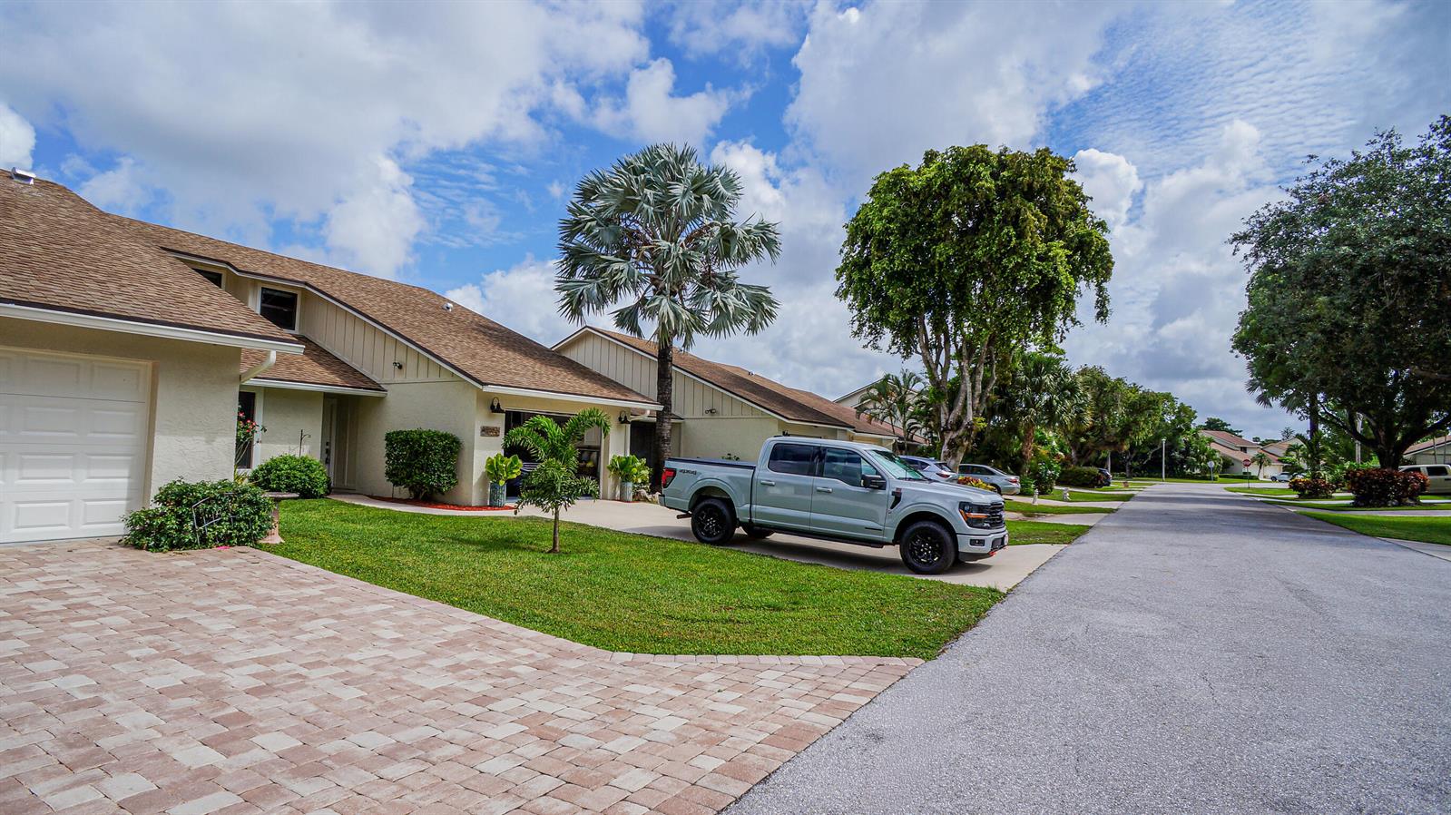 A light-colored pickup truck is parked in the driveway of a suburban house — 11894 Donlin Drive, Wellington FL 33414, WELLINGTON, FL
