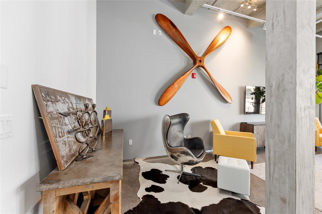A modern living area features a large wooden propeller wall art and a cowhide rug — 302 SE BROADWAY STREET UNIT 330, OCALA, FL