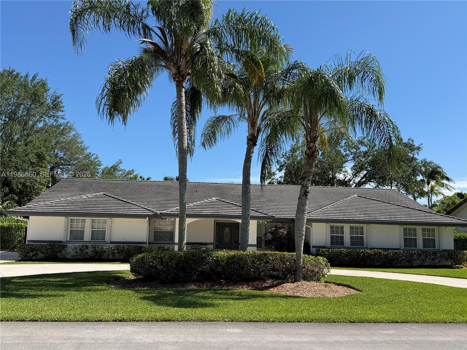 A single-story house with a gray tile roof and three palm trees in the front — 10422 SW 121st St, Miami FL 33176, MIAMI, FL
