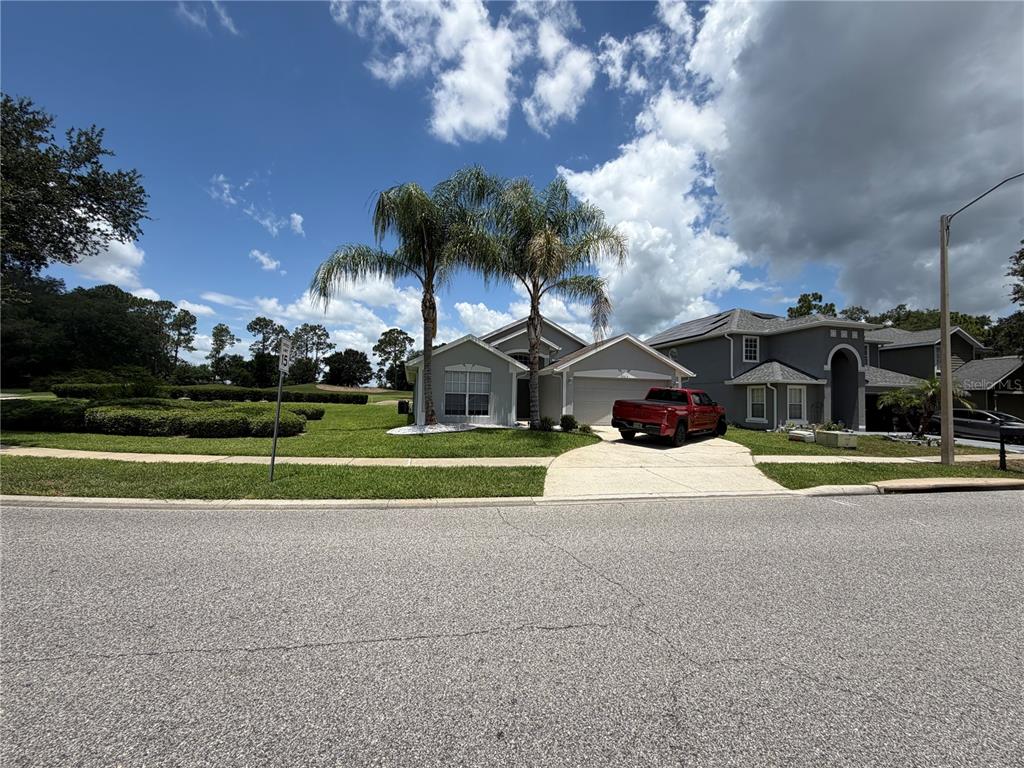 A single-story house with a red truck in the driveway and two palm trees — 2004 HEMINGWAY AVENUE, HAINES CITY, FL