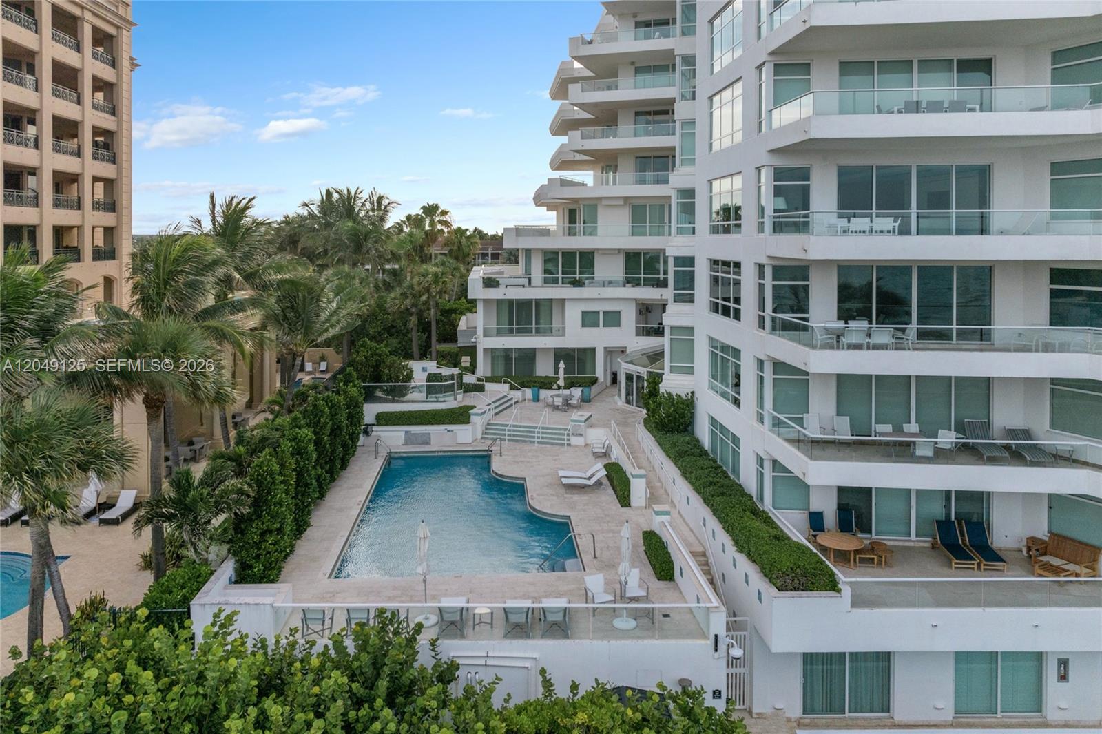 An aerial view shows a swimming pool area nestled between two large residential buildings — 2494 S Ocean Blvd, Boca Raton FL 33432, BOCA RATON, FL