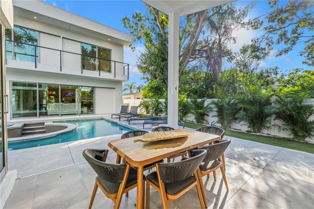 A modern two-story house with a swimming pool and patio dining area in the backyard — 2564 ARLINGTON STREET, SARASOTA, FL