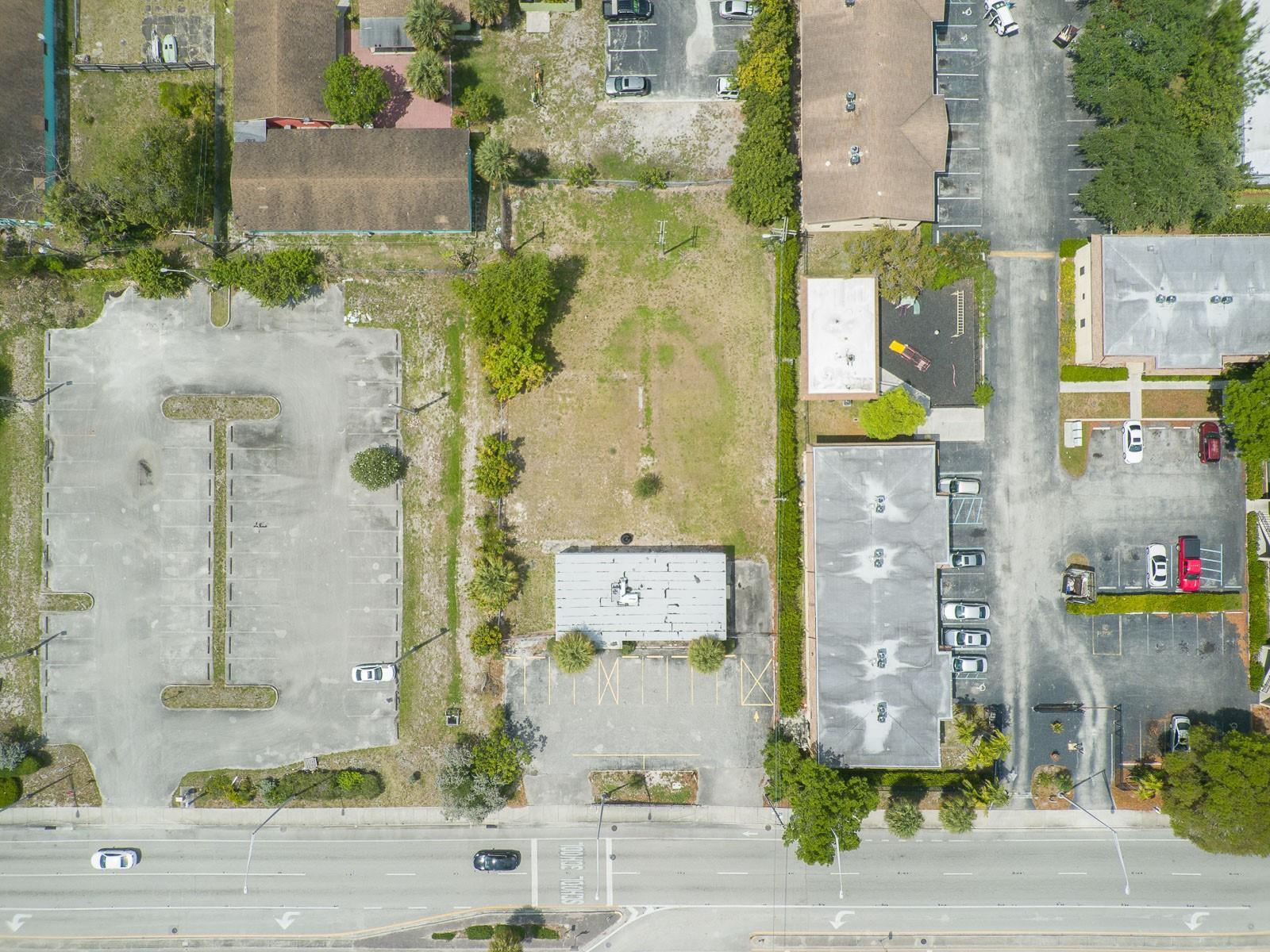An aerial view shows a rectangular lot with a small building and parking areas — 1744 Lake Worth Road, FL 33460, FL