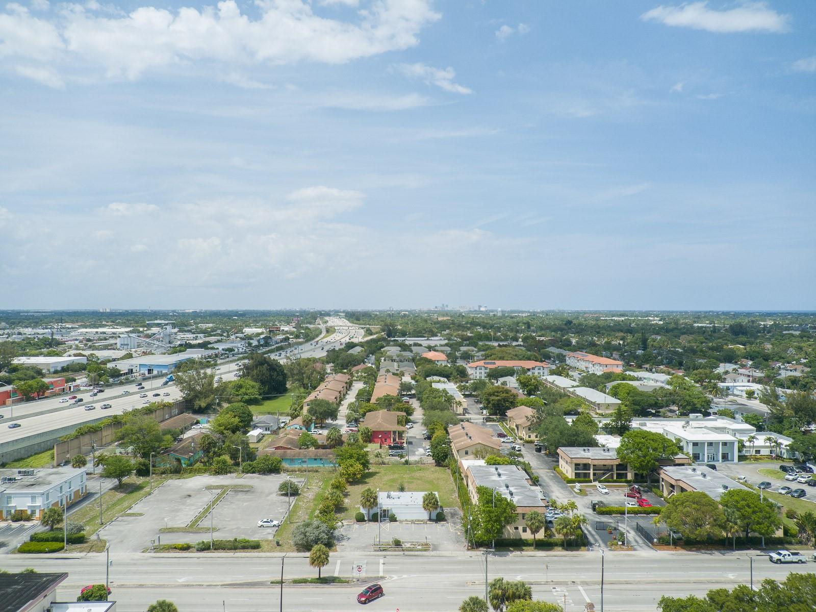 An aerial view shows a suburban neighborhood with apartment buildings, parking lots, and a highway — 1744 Lake Worth Road, FL 33460, FL