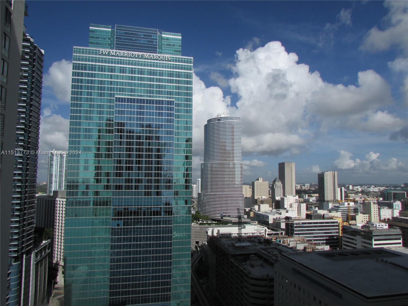 An exterior view of the JW Marriott Marquis skyscraper and surrounding buildings in downtown Miami — 300 S Biscayne Blvd # 2709, Miami FL 33131, MIAMI, FL