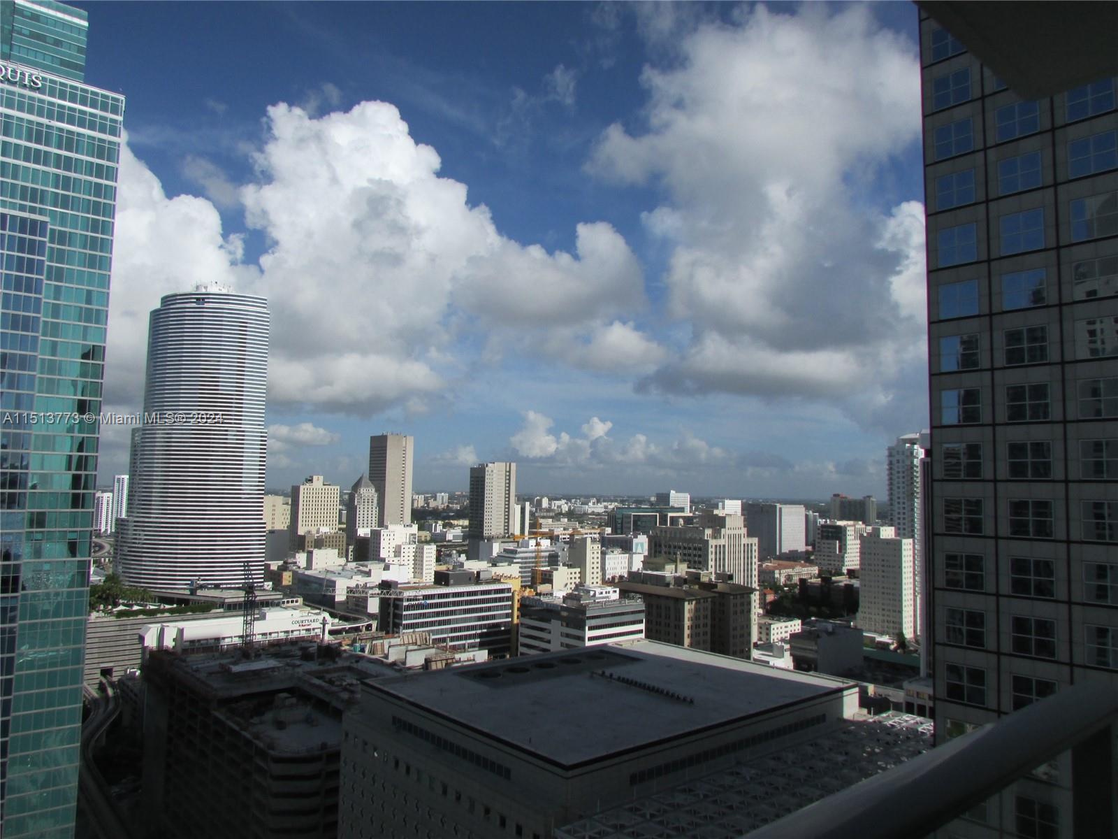 A high-angle view of a dense city skyline featuring numerous skyscrapers under a cloudy sky — 300 S Biscayne Blvd # 2709, Miami FL 33131, MIAMI, FL