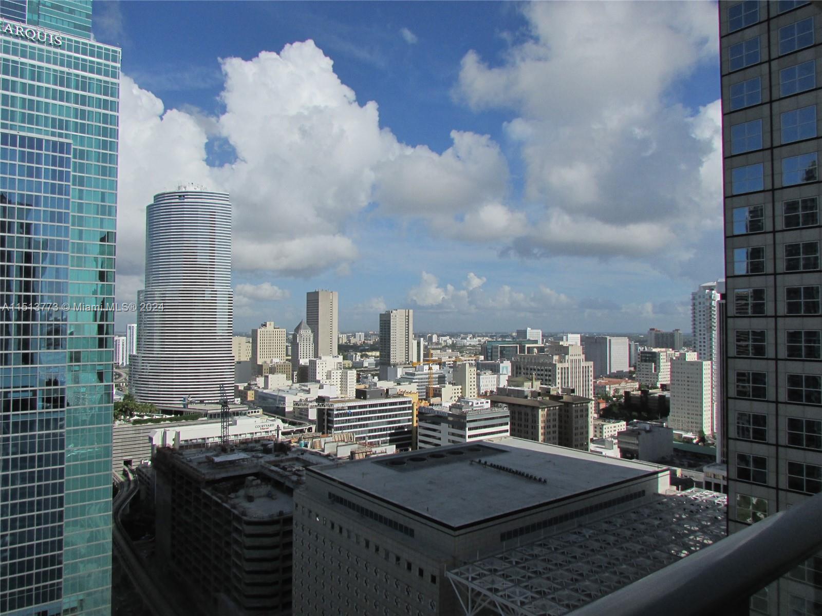 An elevated view of the Miami skyline featuring various high-rise buildings under a cloudy sky — 300 S Biscayne Blvd # 2709, Miami FL 33131, MIAMI, FL