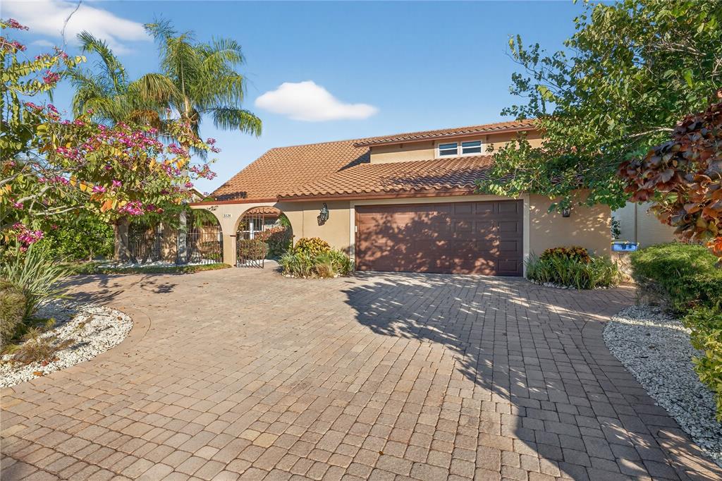 A single-story house with a tile roof, brown garage door, and a paved driveway — 5124 SOUTH SHORE DRIVE, NEW PORT RICHEY, FL