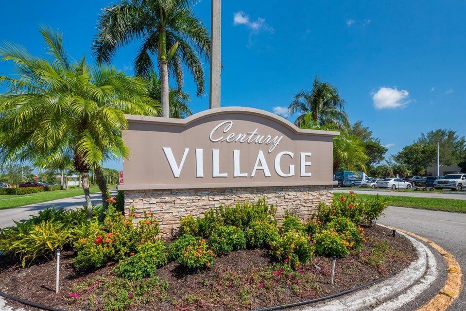A stone-based monument sign for Century Village stands in a landscaped area with palm trees — 393 Windsor, West Palm Beach FL 33417, WEST PALM BEACH, FL