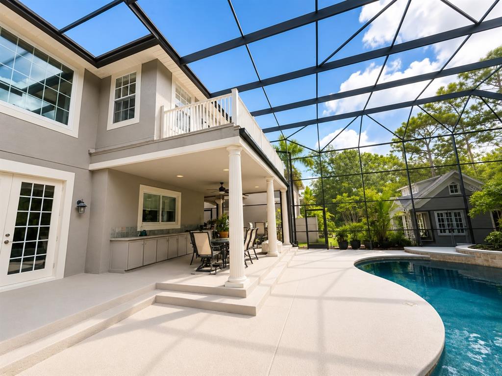 An aerial view shows a large house with a screened-in pool and a nearby lake — 3909 CASSIA DRIVE, ORLANDO, FL