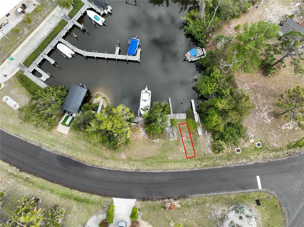 An aerial view shows a waterfront property with a boat dock and a red-outlined area — 2613 LEAR ROAD B LOT 14, ENGLEWOOD, FL