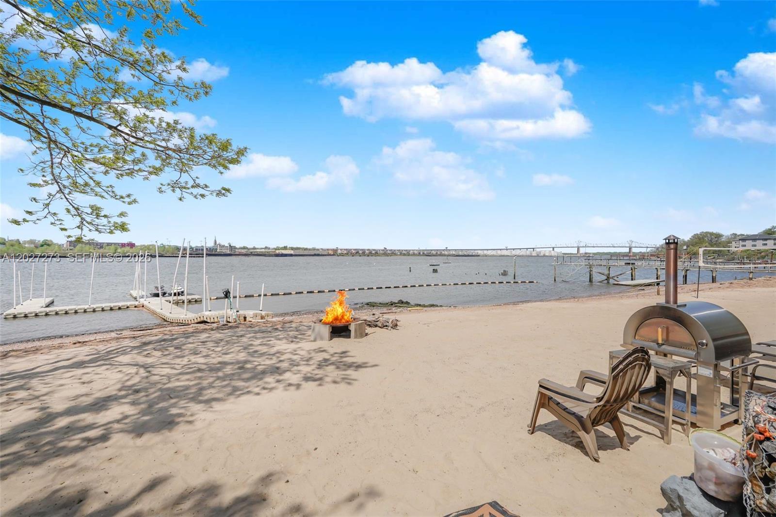 A sandy beach features a fire pit, a pizza oven, and a wooden dock — 30 Aviva Ct, NY 10307, NY