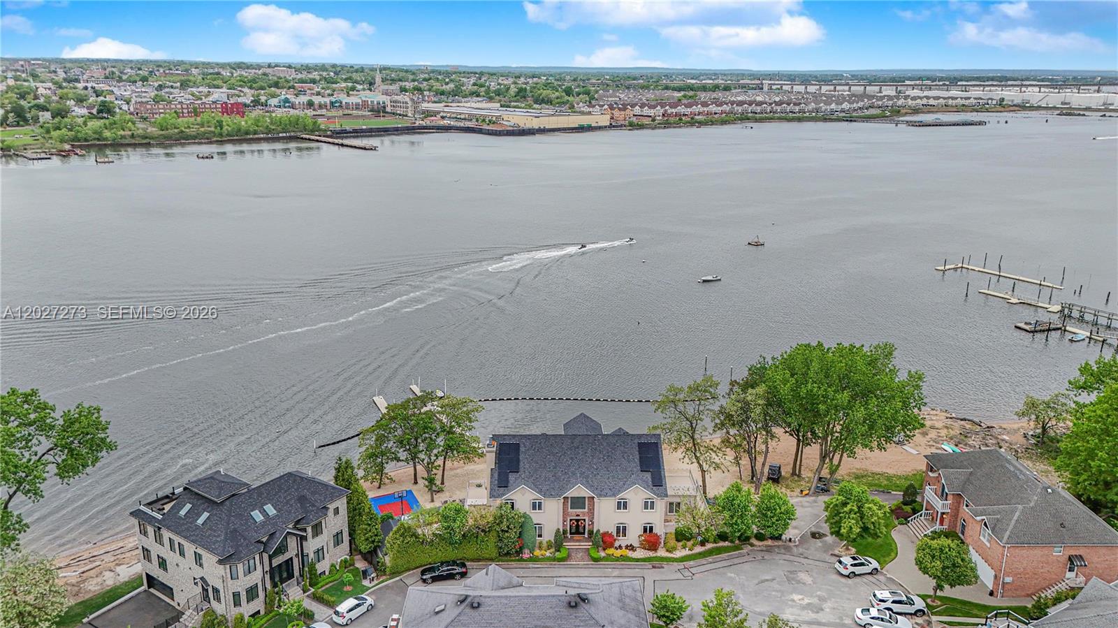 An aerial view shows a waterfront house with a private dock and sandy beach — 30 Aviva Ct, NY 10307, NY