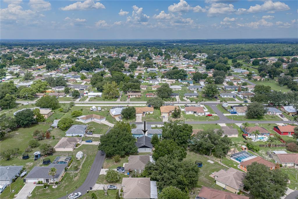 An aerial view shows a residential neighborhood with a marked house and surrounding properties — 8054 KAITLIN CIRCLE, LAKELAND, FL