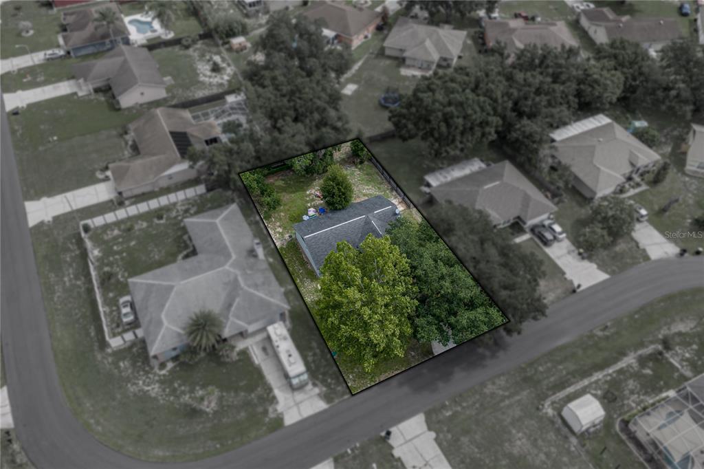 An aerial view shows a house with a gray roof on a rectangular lot — 8054 KAITLIN CIRCLE, LAKELAND, FL