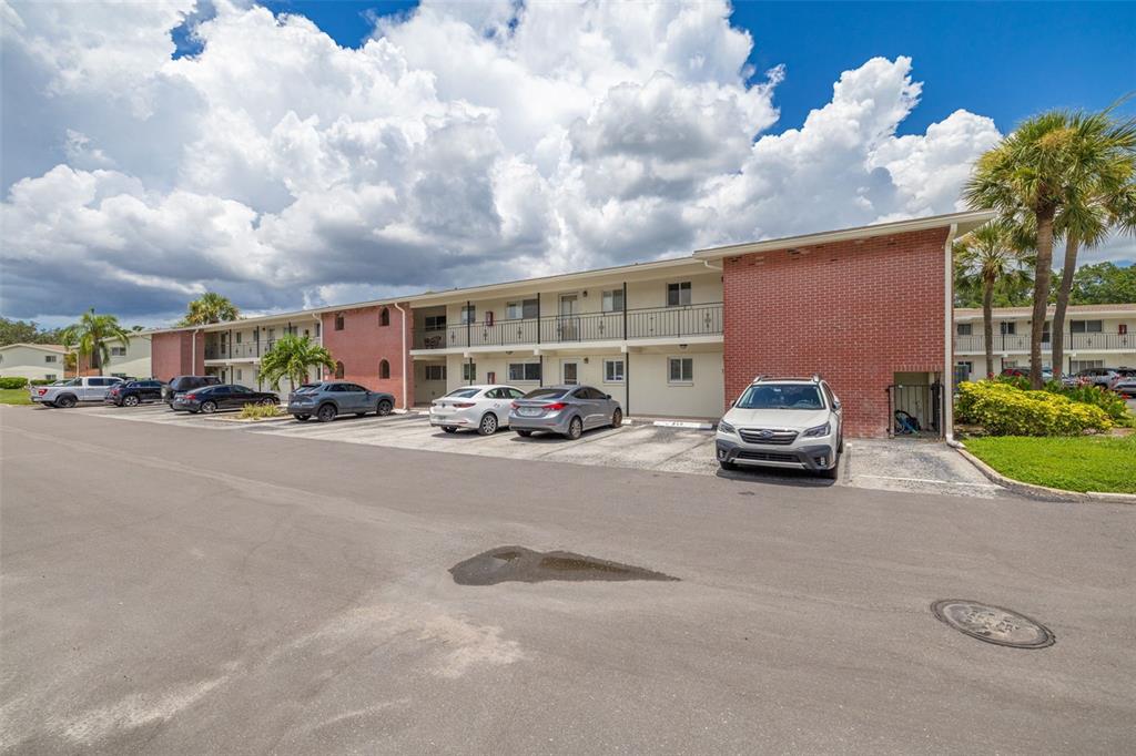 A two-story apartment building with a brick facade and a parking lot in front — 4550 OVERLOOK DRIVE NE UNIT 155, ST PETERSBURG, FL