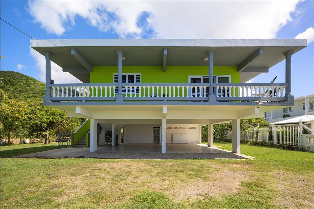 A two-story house with a lime green upper level and a covered ground-level patio area — CARR. 3 BO. GUARDARRAYA SECTOR COOPERATIVO UNIT KM 113.3, PATILLAS, PR