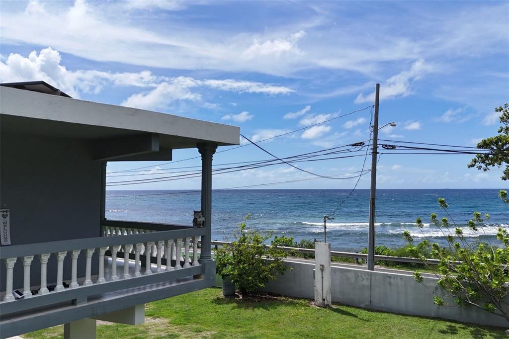 A gray house with a balcony overlooks the ocean under a blue sky — CARR. 3 BO. GUARDARRAYA SECTOR COOPERATIVO UNIT KM 113.3, PATILLAS, PR