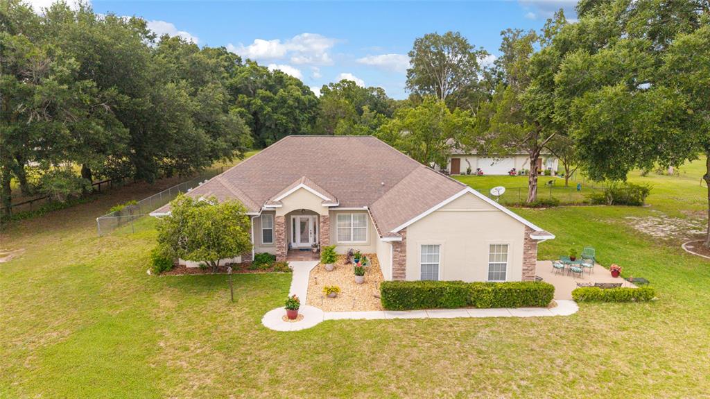 An aerial view of a single-story house with a tan exterior and a brown roof — 435 NE 155TH STREET ROAD, CITRA, FL